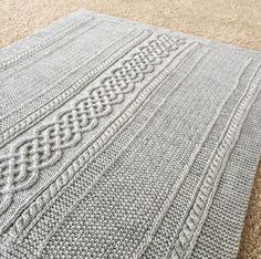 a gray rug is laying on the floor