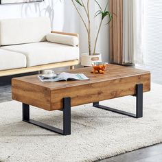 a living room with a white couch and wooden coffee table in front of a window