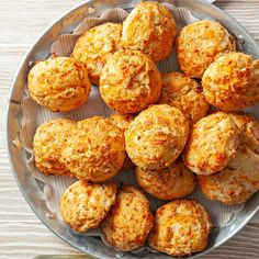 a plate full of muffins sitting on top of a wooden table