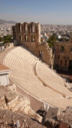 an old amphit sits in the middle of a city with lots of ruins on it