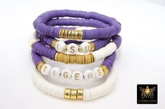 Purple and Gold Bracelet in Heishi Beads by Regina Harp Designs These bracelets are in a purple, white and gold colors with your choice of bracelet style. They can be made with our other bead colors as well; message us if you would like to customize your bracelet. If you need a smaller or extra large size in the bracelet, please leave us a note with your order. To measure your wrist size you can wrap a piece of string around your wrist and mark it. Then lay the string down and see how long it is Lsu Beaded Bracelets, Clay Bead Bracelet Ideas Lsu, Heishi Bracelet Lsu, Team Clay Bead Bracelets, Purple Clay Beads Bracelet, Lsu Bracelet, Lsu Nails, Purple Clay Bead Bracelet, Bracelet Violet