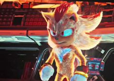 sonic the hedgehog is standing in front of a computer screen with glowing blue eyes