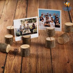 some logs are sitting on the floor next to a photo and two small pieces of wood that have been cut in half