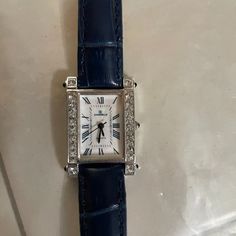 Charmelle Watch With Swarovski Crystals And Brand New Navy Blue Leather Band Size 14r. New Battery June 2022. Very Nice Casual Watch. Goes Great With Denim. Elegant Formal Jewelry With Silver-tone Hardware, Elegant Blue Diamond Watch For Anniversary, Classic Blue Rectangular Watch Accessories, Silver Diamond Watch With Palladium Hardware, Caiso Watch Metal Navy, Elegant Blue Leather Jewelry, Elegant Blue Watch With Bracelet Strap, Elegant Blue Diamond Watch, Elegant Blue Leather Watch