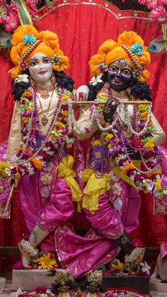 two men dressed in colorful costumes standing next to each other