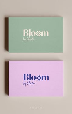 two business cards with the words bloom by choice on them, one in purple and one in green