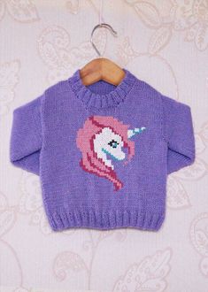 a purple sweater with an image of a unicorn on it