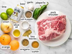 ingredients to make an entree laid out on a marble counter top, including meat and vegetables