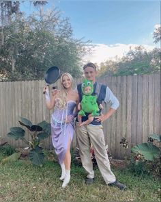 a man and woman are dressed up as disney princess and the frog with their child