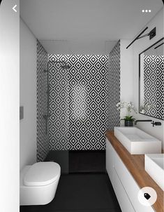 a modern bathroom with black and white wallpaper