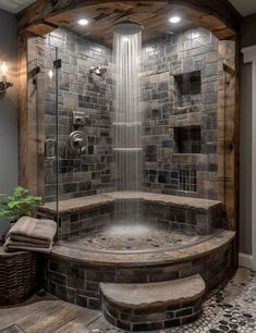 a walk in shower sitting next to a brick wall and wooden floored area with stone steps