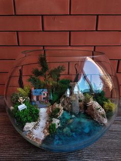 a glass bowl filled with water and plants