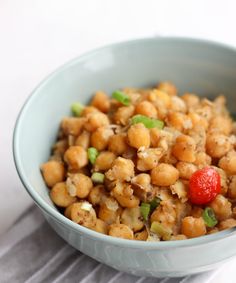 a bowl filled with chickpeas and garbanzo on top of a table