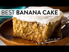 a piece of banana cake sitting on top of a wooden plate next to a fork