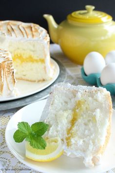 there is a piece of cake on the plate with lemon wedges next to it