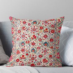 a red and blue pillow sitting on top of a couch