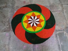 this is an image of a circular design painted on concrete with colors and black, red, green, yellow