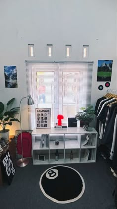 a room that has some clothes hanging on the wall and a rug in front of it