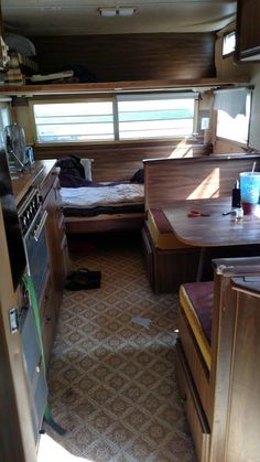 the inside of a camper with wood furniture