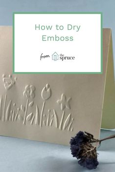 a card with the words how to dry emboss on it and a dried flower