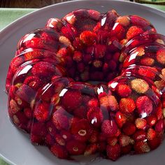 a cake covered in jelly sitting on top of a white plate