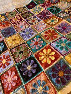 a crocheted blanket with flowers on it