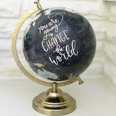 a black and white globe with writing on it that says you are going to change the world