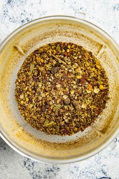 a blender filled with spices on top of a counter