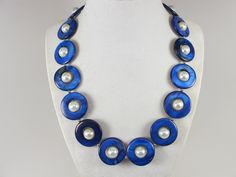 Statement mother of pearl  blue and white necklace,  blue and white shell Pearl Necklace Necklace, blue necklace, white  statement shell   Necklace is made from blue mother of pearl donut beads and white glass beads 10mm,  measures approx. 19" plus an additional 4" inches with silver extender. 1 Strands, light weight. Closure is a  lobster clasp with silver extender chain with bead dangle. My beautiful jewelry makes warm and personal gift for you, your family and friends, and all come in jewelry Elegant Blue Shell Necklace As A Gift, Elegant Blue Shell Necklace For Gift, Elegant Handmade Blue Shell Necklace, Handmade Blue Pearl Necklace, Handmade Blue Mother Of Pearl Jewelry, Blue Shell Beaded Necklaces, Blue Shell-shaped Necklaces, Blue Beaded Shell-shaped Necklace, Handmade Blue Shell-shaped Necklace