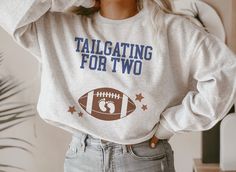 "🏈 Introducing our Football Pregnancy Announcement Sweatshirt, a stylish and playful way to share your exciting news. This Football Sweater is perfect for gender reveals and sports-themed baby showers, making it a memorable gift for expecting dads. Get ready to score big with this unique and delightful crewneck! So what are you waiting for? Click ADD TO CART now! 👕 PRODUCT INFO This unisex heavy blend crewneck sweatshirt and hoodie are pure comfort. These garments are made from polyester and cotton. This combination helps designs come out looking fresh and beautiful. The collar is ribbed knit, so it retains its shape even after washing. .: 50% cotton, 50% polyester .: Medium-heavy fabric (8.0 oz/yd² (271.25 g/m .: Loose fit .: Sewn-in label .: Runs true to size ✏️ DESIGN Designs are prin Football Gender Reveal Shirts, Football Pregnancy Announcement, Football Gender Reveal, Gifts For Expecting Dads, Sports Baby Shower Theme, Football Sweater, Gender Reveals, Baby Shower Gender Reveal, Exciting News