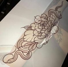 an artistic tattoo design on the side of a white piece of paper with black ink