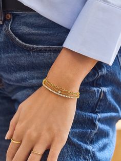 Instantly elevate your wrist stack with the Zora 18K Gold Layered Bracelet — a twist on our best-selling Skye Bracelet. Its three individual chain layers go on easily with a single clasp. Crafted from 18K gold plated sterling silver and accented with cubic zirconia stones, this bracelet is the chicest everyday essential for effortless style. Gold Silver Bracelet Stack, Stackable Gold Plated Chain Bracelet, Gold Stackable Chain Bracelet For Everyday Luxury, Gold Double Band Bracelets, Gold Stackable Diamond Bracelet For Everyday Luxury, Gold Stackable Tennis Bracelet For Everyday Luxury, Dainty Gold Stackable Diamond Bracelet, Dainty Gold Diamond Stackable Bracelet, Stackable Double Band Gold Bracelets