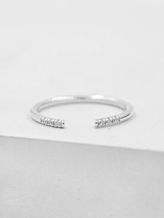 This ring is a minimalistic take on our best-selling eternity band. The ring features six stones set on a very thin round band. The outward facing part of the ring is open for design purposes. Can be adjusted half a size up or down. This ring looks great on its own for a clean, modern and minimal look or stacked with several of our other stackers. Ring is Rhodium plated brass with cubic zirconia Please read my shop policies to learn more about the composition and proper care for each item purcha Midi Rings Silver, Pebble Ring, Birthstone Stacking Rings, Knuckle Ring, Full Eternity Ring, Midi Ring, Silver Stacking Rings, Knuckle Rings, Ring Fit