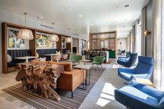 a living room filled with lots of furniture and decor on top of carpeted flooring