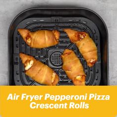 four air fryer pepperoni pizza crescent rolls on top of an air fryer