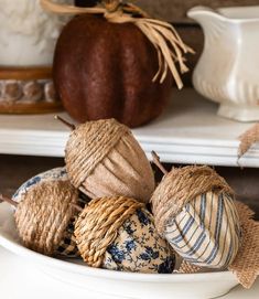 a bowl filled with burlocks and twine on top of a table