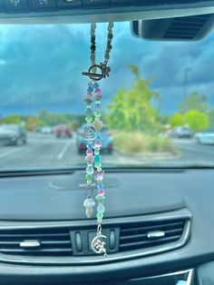 a car dashboard with beads hanging from the dash