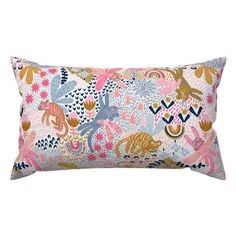 a rectangular pillow with colorful flowers and animals on the front, along with a white background