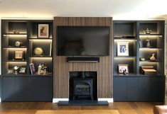 a living room filled with furniture and a flat screen tv mounted on a wall above a fire place