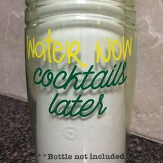 a glass jar with the words water now cocktails later written in green on it