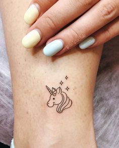 a woman's leg with a small tattoo of a unicorn on her left side