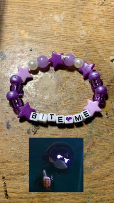 a purple bracelet with white letters and pink stars on it, next to a photo of someone's name