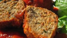 meatloaf with tomato sauce and spinach leaves on the side, ready to be eaten