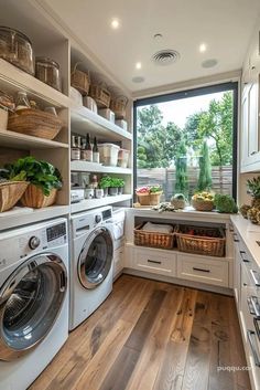 a washer and dryer in a room with open shelves on the wall next to each other