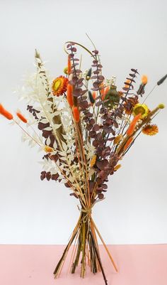 a vase filled with lots of different types of flowers