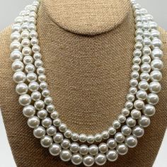 Introducing the exquisitely timeless Classic 3 Strand Pearl Necklace, a true embodiment of elegance and sophistication! This stunning white pearl necklace is a must-have addition to your jewelry collection, destined to become a classic piece that will never go out of style. Meticulously crafted with the utmost delicacy, the design showcases three strands of perfectly round pearls that gracefully caress the skin, creating an effortlessly elegant look and feel. The necklace is adorned with a sterl Vintage White Double Strand Pearl Necklace, Multi-strand Pearl White Pearl Necklace For Party, Elegant Pearl White Multi-strand Necklace, Classic Multi-strand Pearl White Necklaces, Vintage Multi-strand White Pearl Necklace, Beads Design, Necklace Elegant, White Pearl Necklace, Strand Necklace