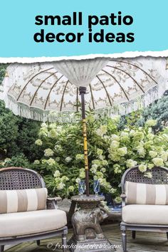 two chairs and an umbrella in the middle of a patio area with flowers on it