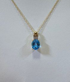 "14ky Blue topaz pendant with diamond accents on 18\" 14ky chain" Yellow Gold Topaz Oval Necklace, Fine Jewelry Yellow Gold Topaz Necklace, Yellow Gold Topaz Necklace Fine Jewelry, Oval Gold Topaz Necklace, 14k Gold Necklace With Accent Stones, Blue Oval Pendant Necklace With Diamond Accents, Blue Topaz Necklaces With Diamond Accents, Yellow Gold Jewelry With Diamond Accents And Blue Topaz, Yellow Gold Blue Topaz Jewelry With Diamond Accents