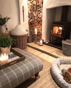 a living room with a fire place and dog bed