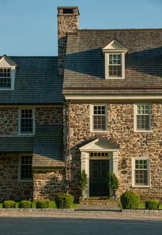 a large stone house with two story windows